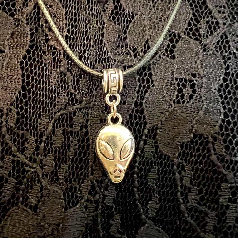 Planetary Visitor Alien Head Necklace on a Black Cord with Saturn Charm ending
